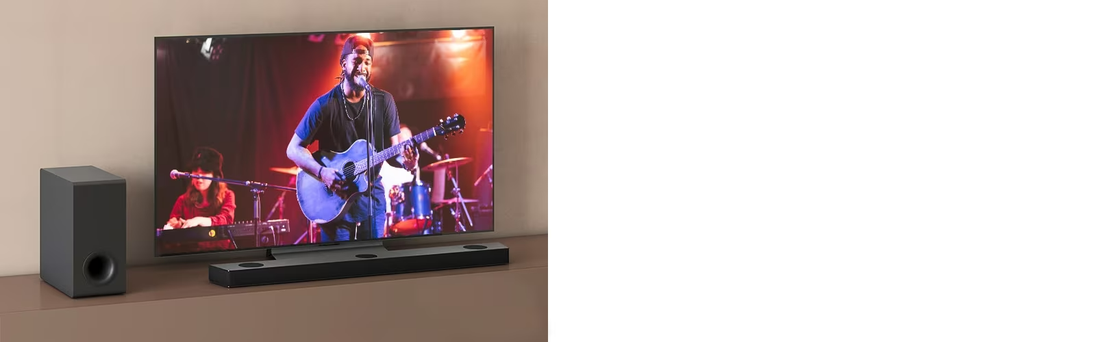 LG TV shows a concert, and LG Sound Bar is placed below LG TV. On the left, sub-woofer is on the brown shelf.