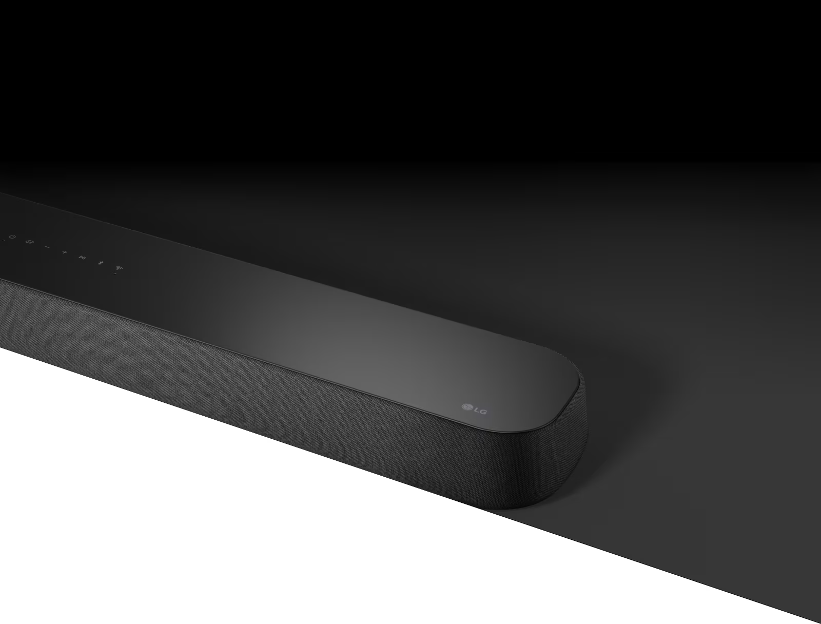 LG Soundbar  SE6S with diagonal view is placed on black coloured area and there is a white coloured area underneath for design purpose.
